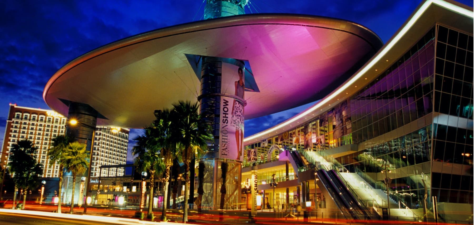 “The Cloud” a 480 foot-long steel structure hovers 128 feet above the Las Vegas Strip, the structure is part of the expansion to the Fashion Show Las Vegas, the “Cloud” provides shad during the day and serves as a colossal image projection surface at night, four LED screens situated just below the cloud broadcast video and events occurring inside Fashion Show, sponsored advertising or synchronize live with Las Vegas events, completion of the 1.9 million square foot mall is set for 2004.