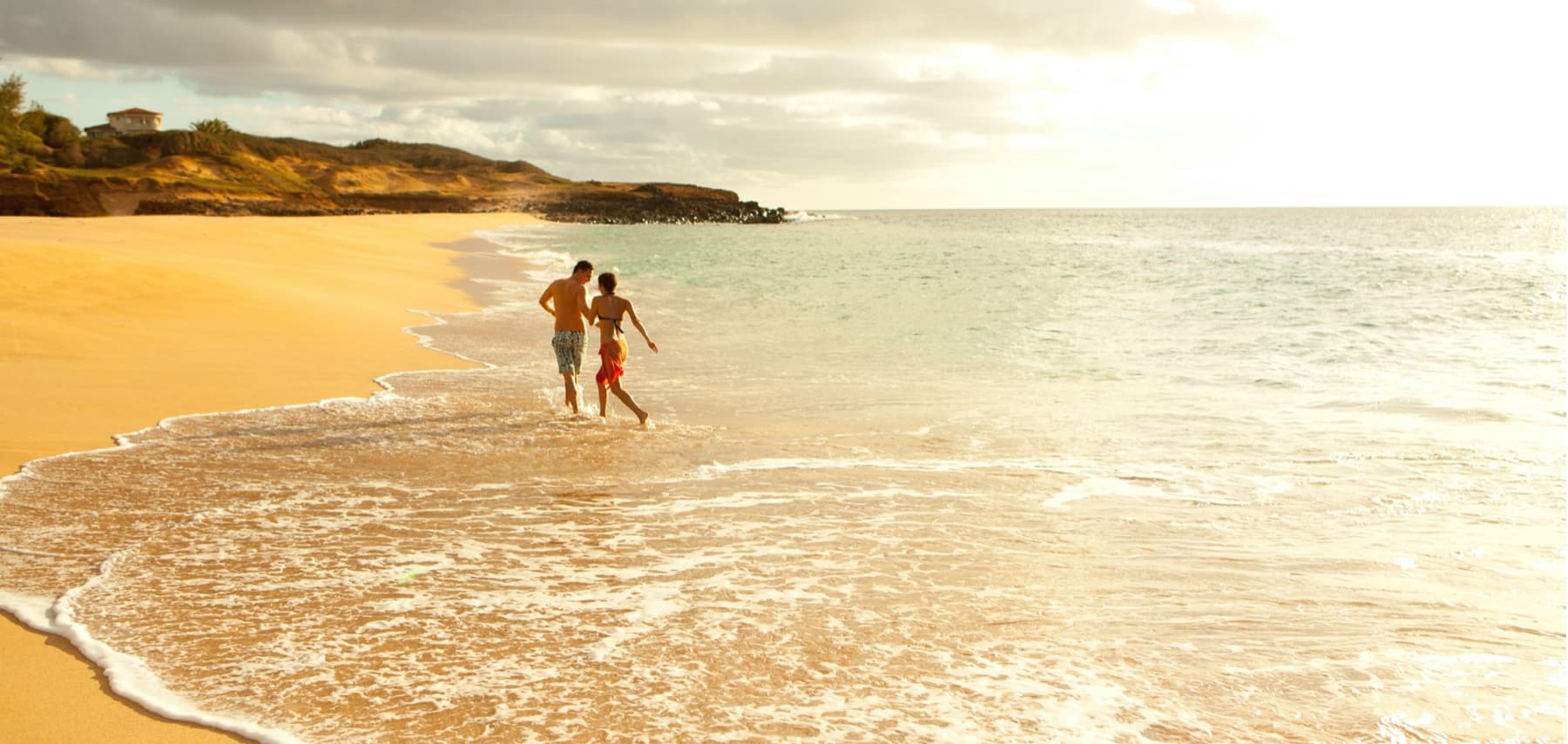 Couple frolic on Papohaku Beach